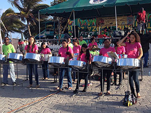 A group of people playing on steel drums